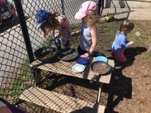 Kids playing outside at picnic table